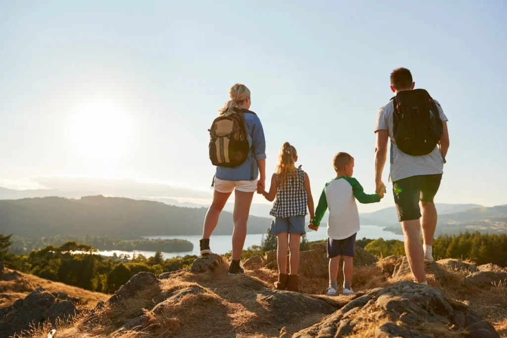 Eco-Friendly Destinations in Morocco : Family hiking through the Cèdre Gouraud Forest in Ifrane, surrounded by tall cedar trees and natural greenery.